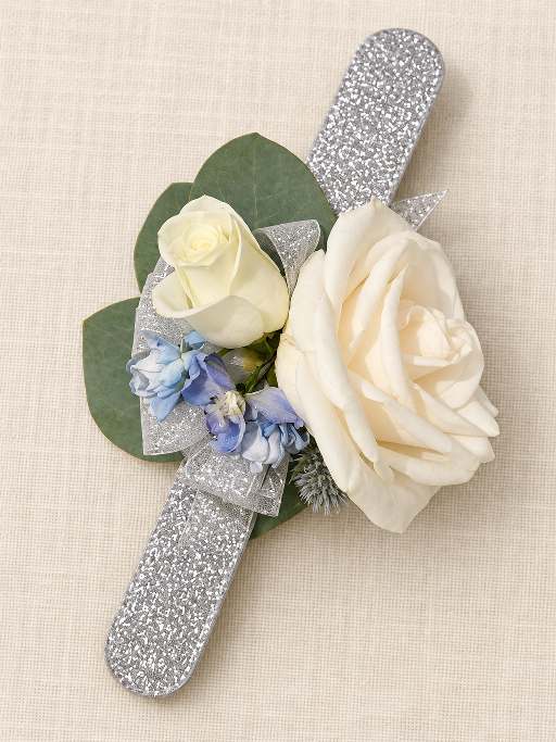 Single white rose boutonniere with eucalyptus leaves.