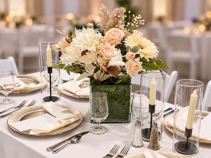 Soft romantic reception centerpiece in muted pinks and creams.