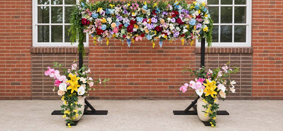 Floral wall backdrop covered in dense blooms for a wedding photo area.