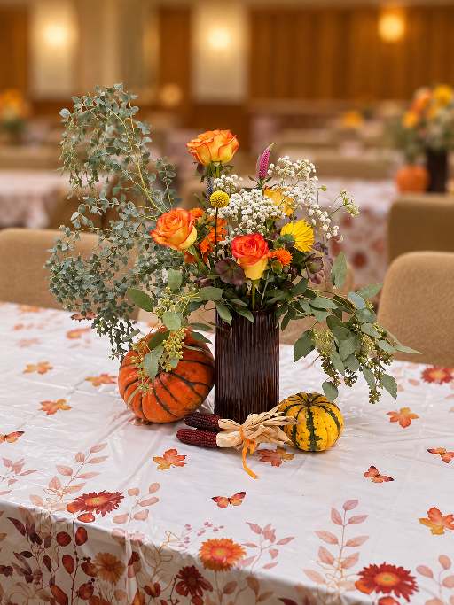 Holiday centerpiece of evergreen branches, berries and candles.